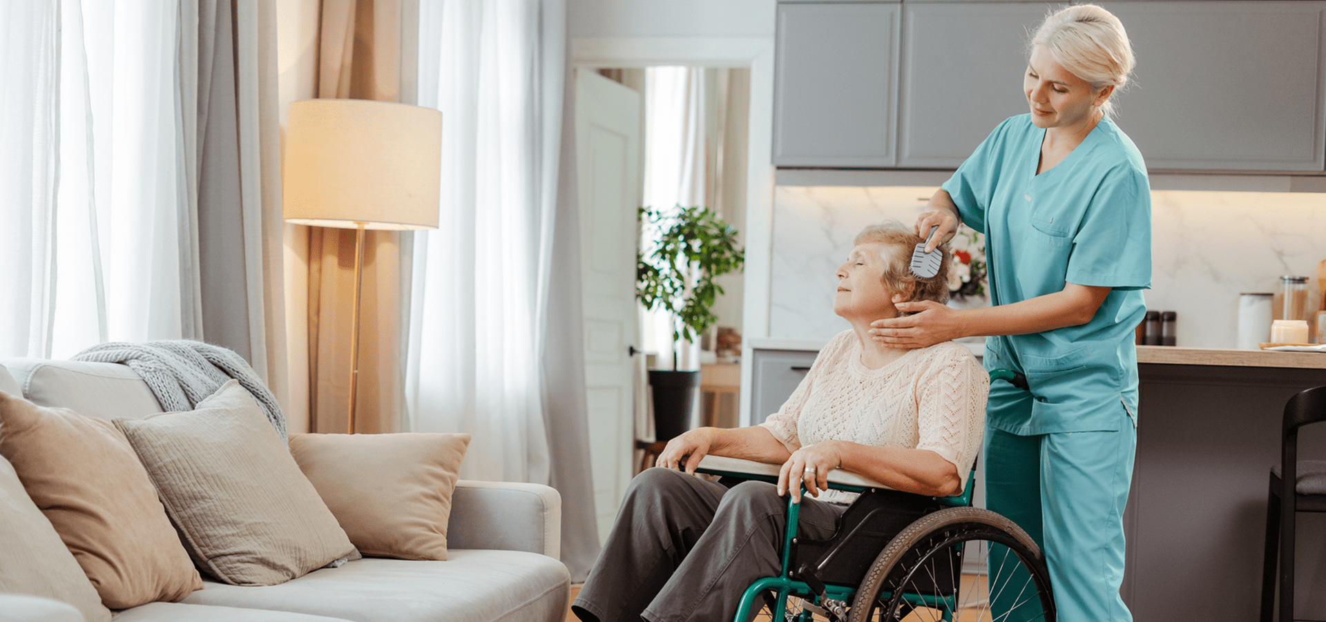 Caregiver helping woman in wheelchair at home.
